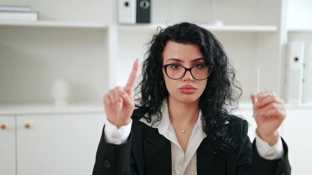 Businesswoman holding cigarette and pointing finger, enforcing no smoking policy in the office. Strict corporate rules, health clean workspace concept, emphasizing prohibition in business environment