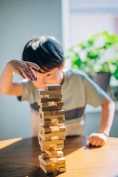 Playing a wooden block balancing game at home