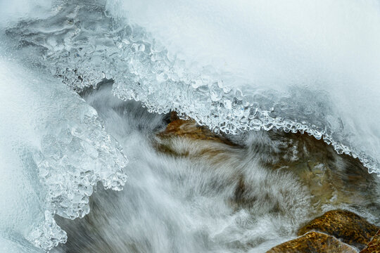 Ice formations over a flowing small river in Villgratental