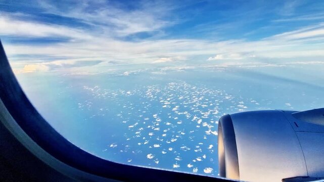 The wonderful panorama of the blue sky with white clouds seen by an airplane passenger through the window