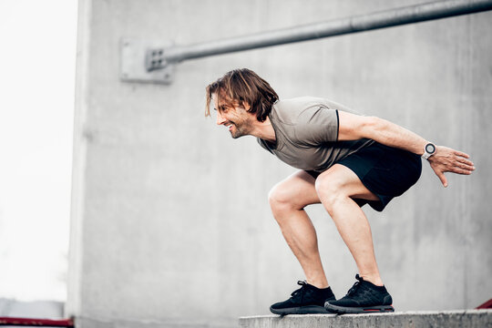 Smiling athlete exercising outdoors
