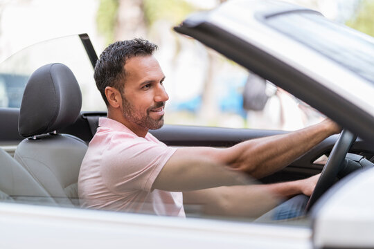 Portrait of man driving convertible