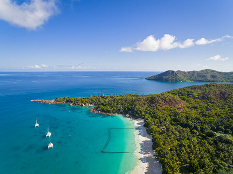 Seychelles, Praslin, Anse Lazio, beach and fishing net, Curieuse Island in the background, aerial view
