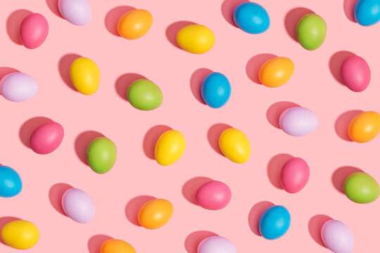 Multi colored easter eggs on pink background