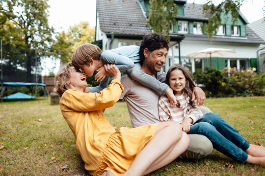 Happy family enjoying in front of house