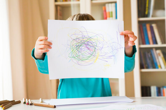 Little girl showing drawing