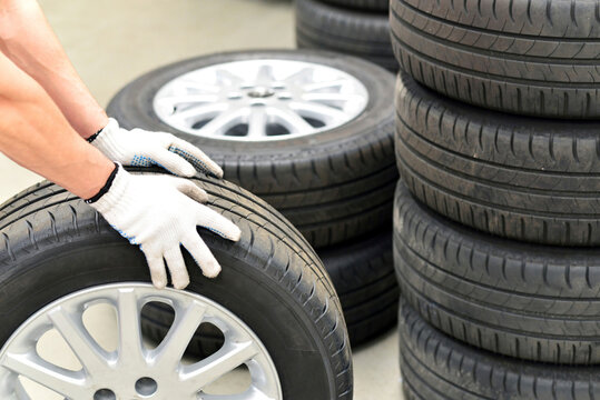 Close-up of car mechanic with tires