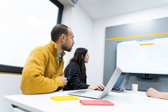 Man and woman discuss a business presentation in the office