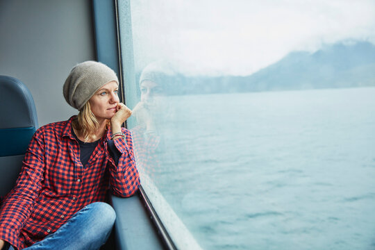 Chile, Hornopiren, woman looking out of window of a ferry