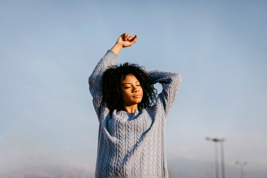 Beautiful young woman outdoors under blue sky