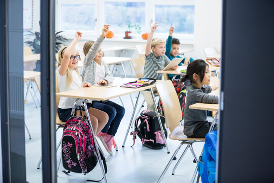 Enthusiastic students eagerly participate in classroom discussion, showcasing their engagement and love for learning