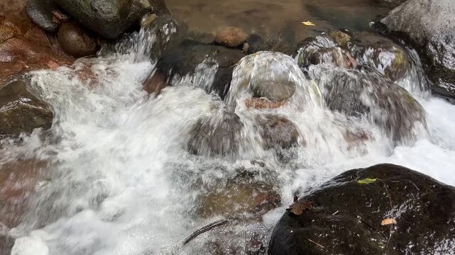 Clear mountain stream flowing over natural rocks 26