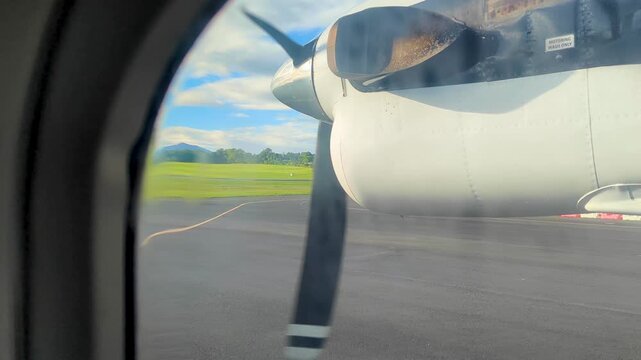 Window view from propeller airplane on runway at Nadi Airport in Fiji, South Pacific