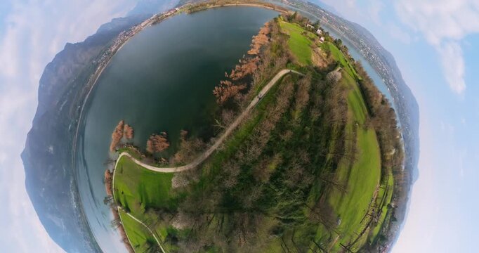 Captivating aerial 360 drone footage showcasing the stunning natural beauty of Monte Barro with its lush green landscape and tranquil lake.