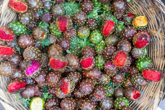 Fresh Prickly Pear Fruits in a Woven Basket with Green and Red Varieties