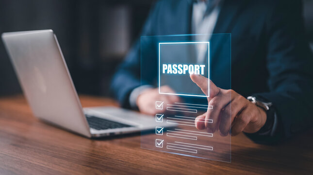 Professional using digital interface to verify passport information on laptop in office setting