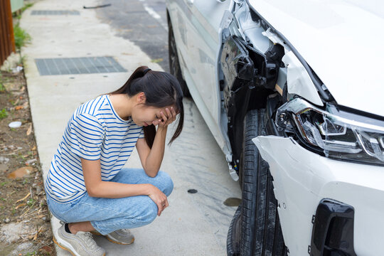 Woman stressed after car accident on road
