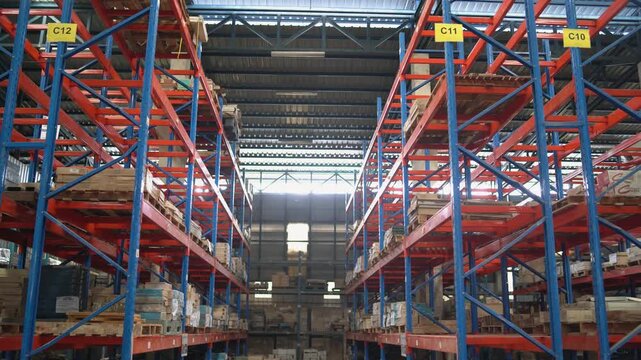 Industrial warehouse interior with storage racks and stacked products.