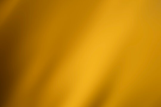 Gold background, Abstract blurred metallic light and elegant golden gradient texture.