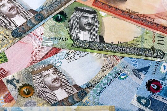 Bahraini dinar money bills pile on table. Bahrain banknotes of BHD currency close up.