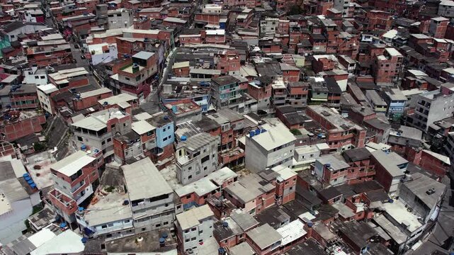 Aerial motion of densely packed favela homes in brazil, showcasing urban sprawl and community living.