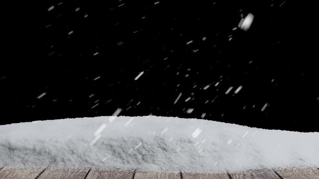 Snow falls on a wooden floor with a pile of snow