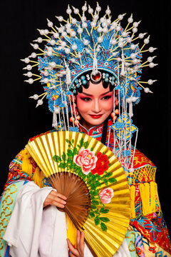 Ancient Asian opera costumes against a black background