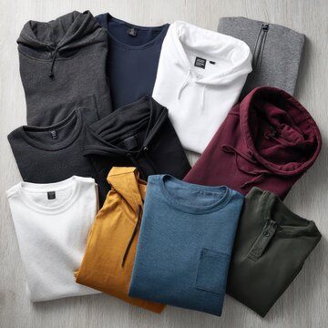 Studio flat lay of casual tops and hoodies for apparel layout design