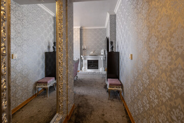 Obraz premium Luxury corridor interior with baroque wallpaper elegant gold framed mirror and fireplace