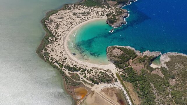 Aerial high overview of Voidokilia Beach and turquoise bay in Pilos Greece, drone establish