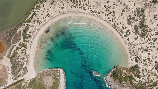 Overview of Voidokilia Beach lagoon in Pilos Messinia Greece, drone top down backdrop as waves enter strait