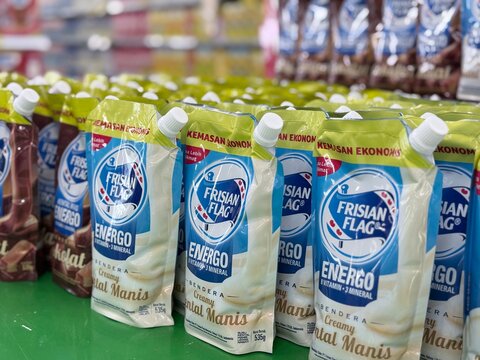 Depok, Indonesia - June 19, 2026: Various flavor variants of Frisian Flag brand's sweet condensed milk in pouch packaging neatly organized on a retail shelf at Tip Top Supermarket in Depok