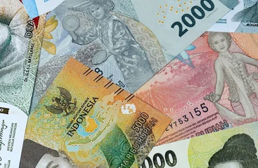 Indonesian rupiah money bills in pile on table. Indonesia IDR currency cash close up © Viktor