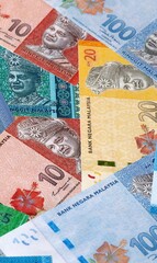 Malaysian ringgit money bills in pile on table. Malaysia MYR currency cash close up © Viktor