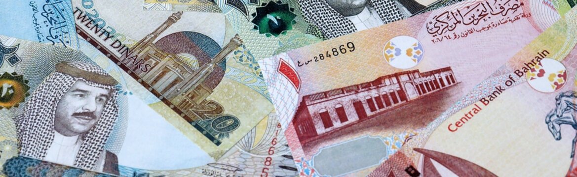 Bahraini dinar money bills in pile on table. Bahrain BHD currency cash close up