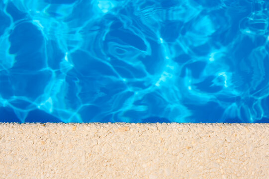Empty space at the hotel pool. View from above on the blue water.