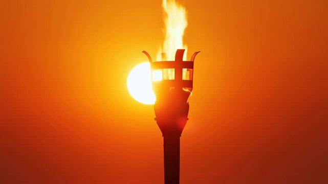 Backlit torch silhouette with rising flame and bright sun halo against vivid orange sky, centered metal cage, strong rim light, dramatic contrast, ceremonial mood