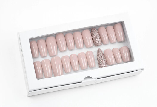 Set of light pink press-on fake nails with glitter accents in white display box press on press-on manicure