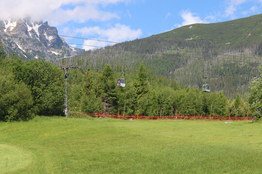 Tatranska Lomnica, Slovakia - May 25, 2024: Cable cars, Tatra Mountains in background