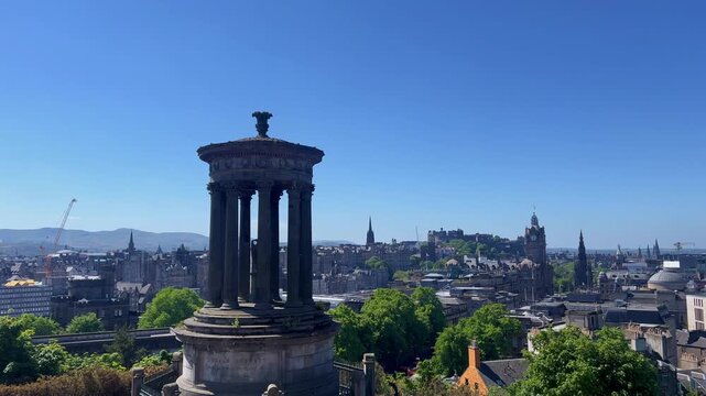 Dugald Stewart Monument overlooking Edinburgh, Scotland from Calton Hill, iconic neoclassical landmark, panoramic Old Town skyline, famous travel destination and historic European cityscape