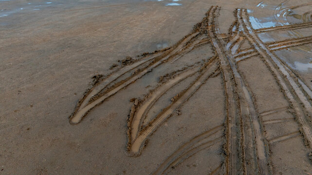 Aerial view wheel tire track on mud, Tire mark imprints on mud vehicles tires footprints transport ground trace or marks textures, wheel treads, Mud terrain.