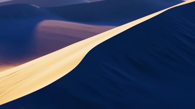 Sinuous desert dune crest dividing sunlit golden slope from deep blue shadowed slope, warm low-angle sunlight shaping flowing curves, ripples, contrast, vast arid landscape
