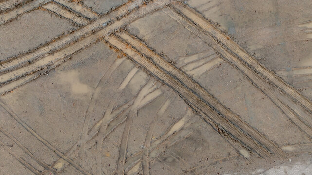 Aerial view wheel tire track on mud, Tire mark imprints on mud vehicles tires footprints transport ground trace or marks textures, wheel treads, Mud terrain.