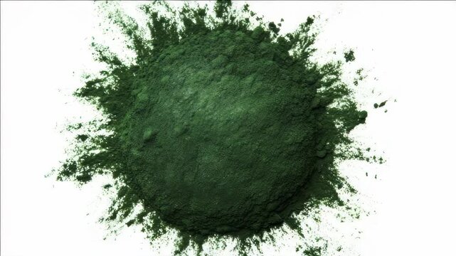 A vibrant green powder creates a circular explosion on a white surface.