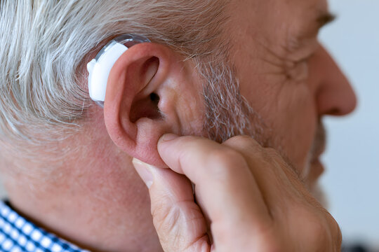 Senior Man Wearing Hearing Aid for Hearing Support and Healthcare