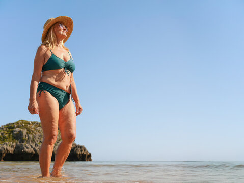 Confident woman with ostomy at seaside