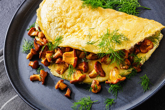 Egg omelet with fried wild chanterelles and dill