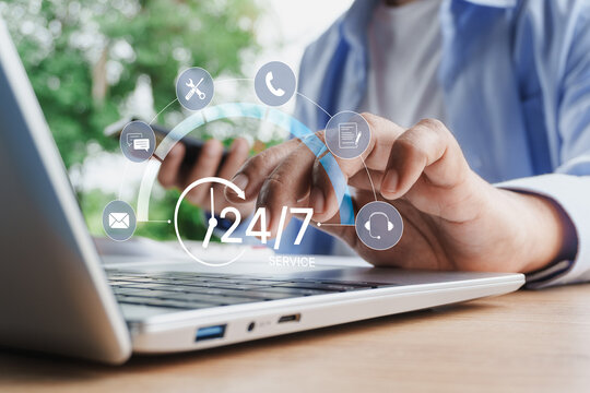 Business Professional Using Smartphone and Laptop with 24 7 Customer Support Interface Digital Communication Help Desk Contact Center Omnichannel Service and Remote Technical Assistance Concept