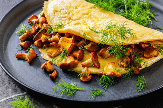 Egg omelet with fried wild chanterelles and dill