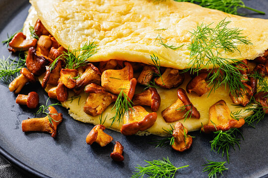 Egg omelet with fried wild chanterelles and dill